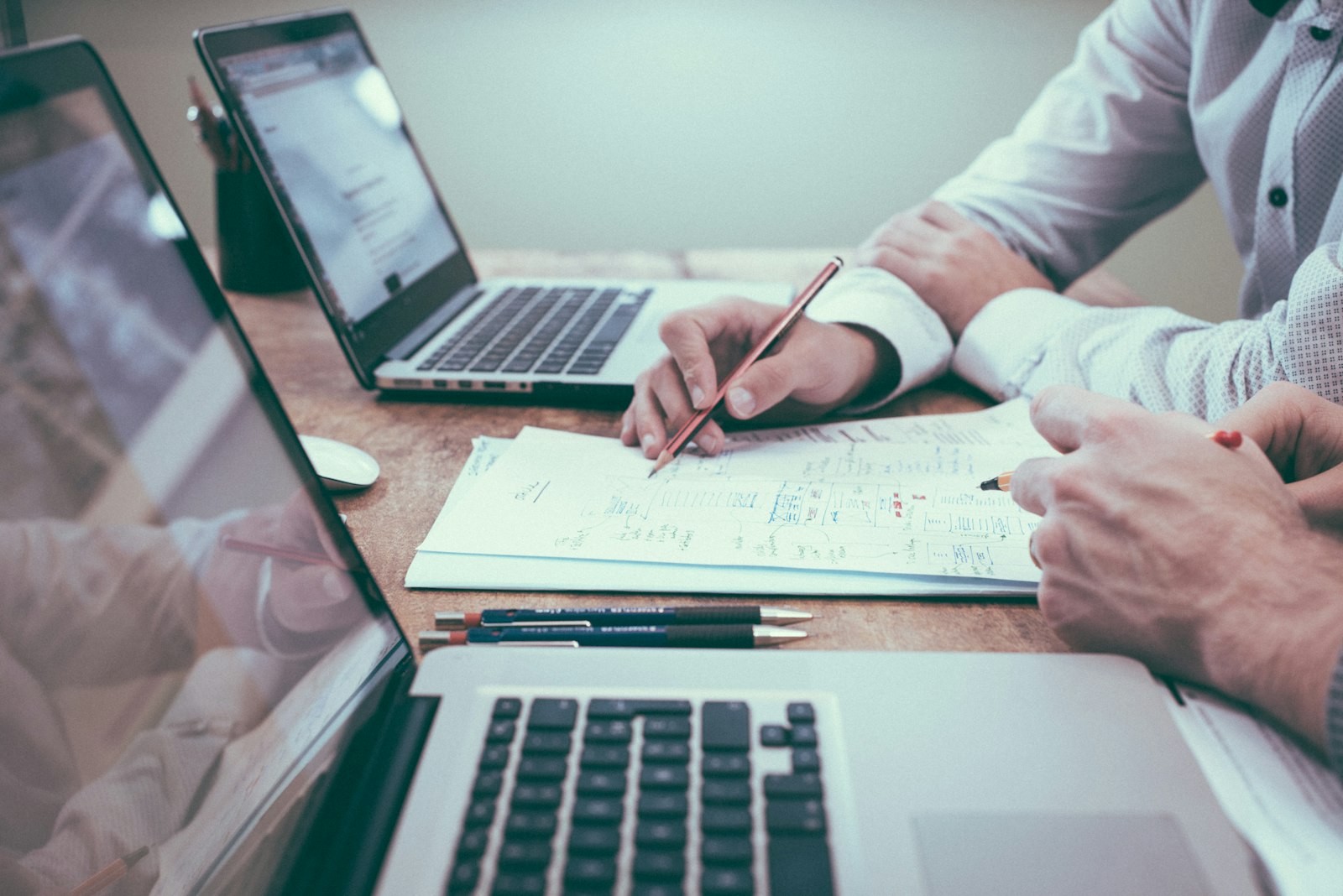 Advisers reviewing documentation at a desk